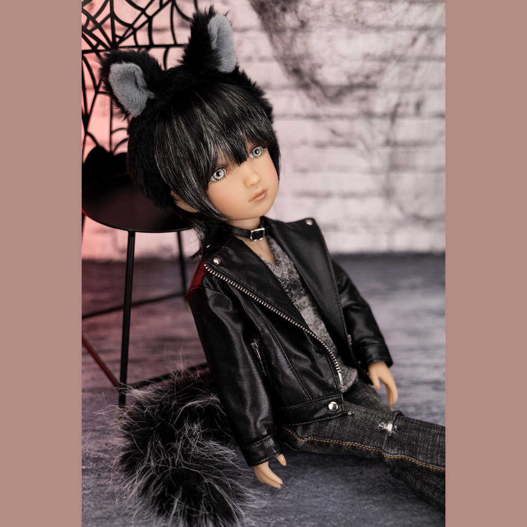 Ruby red doll Kaiden wearing a black leather jacket and cat ears back jeans sitting down.