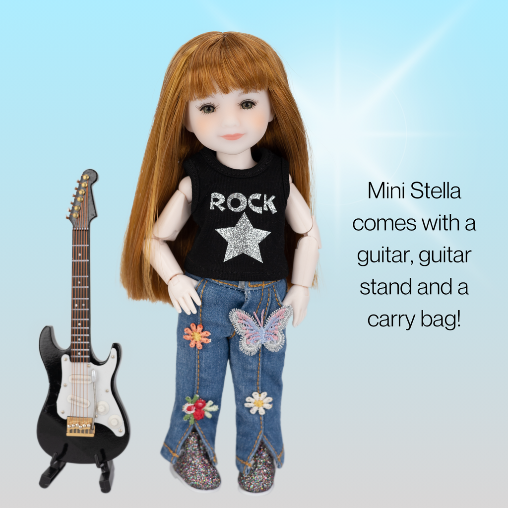 Doll with red hair wearing a 'Rock' shirt and jeans next to a guitar and guitar stand on a light blue background.