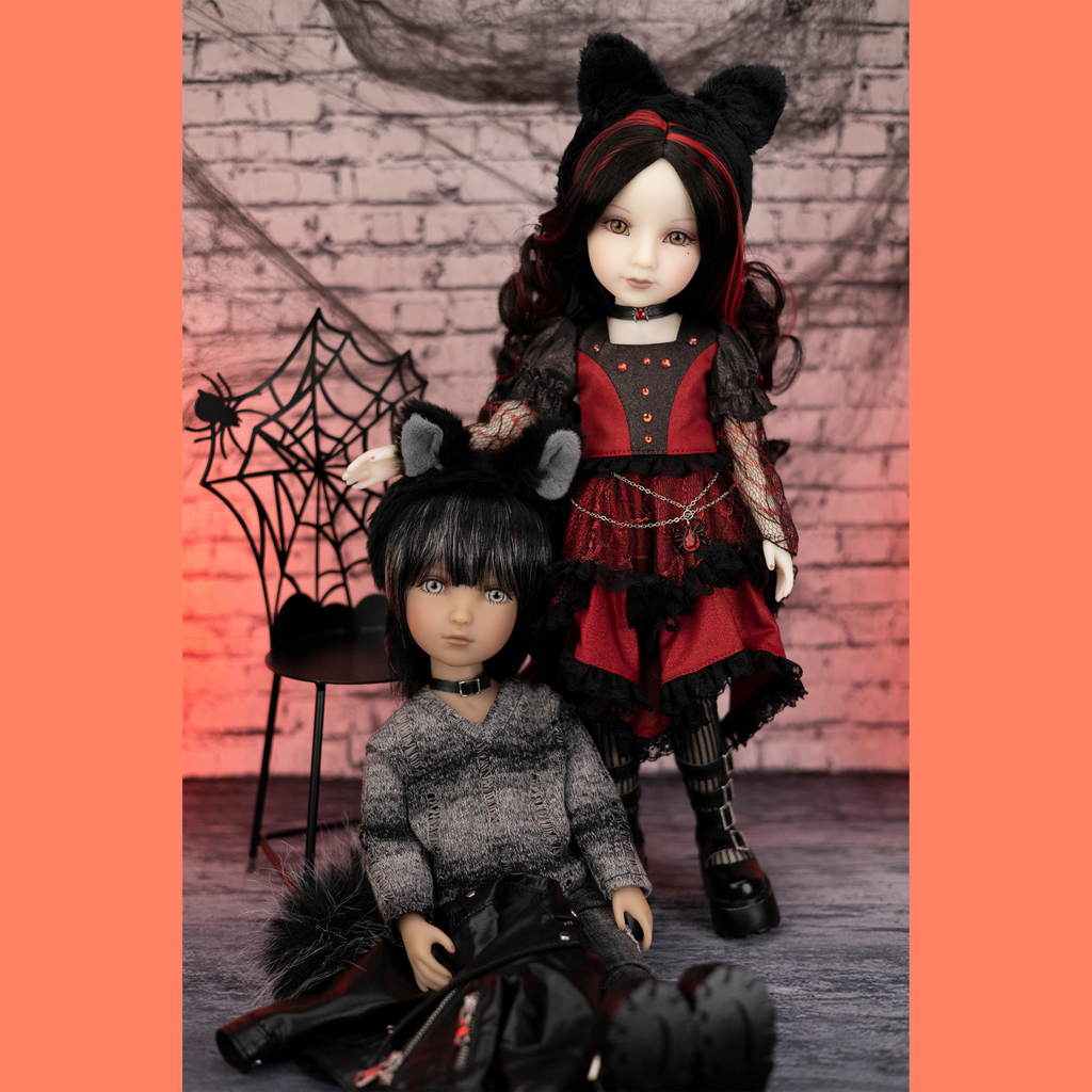 Two halloween edition ruby red dolls in red and black gothic cat outfits.