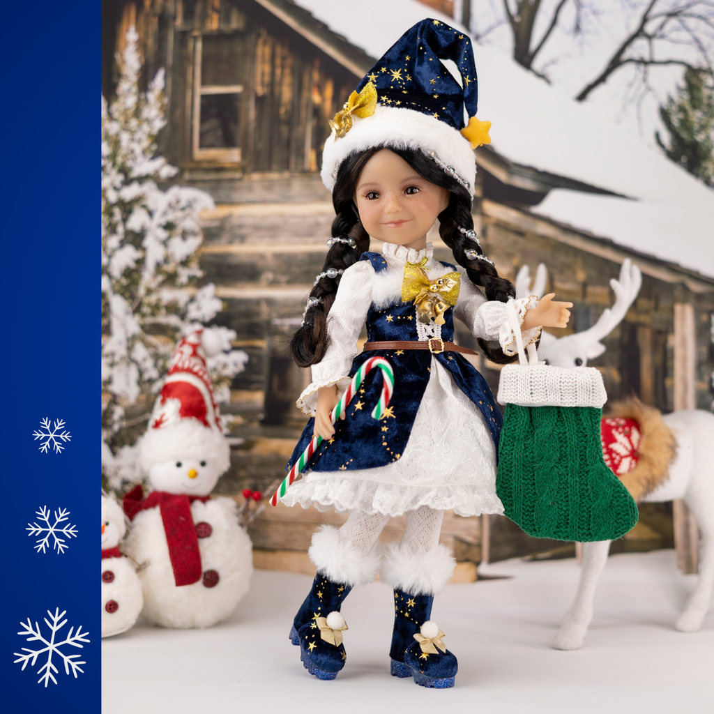 Ruby Red 2025 Holiday edition doll Carol, with festive blue and white outfit and accessories, surrounded by Christmas decorations.